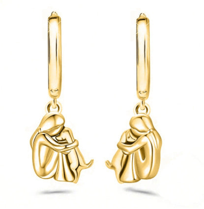 A little girl and a dog embrace earrings